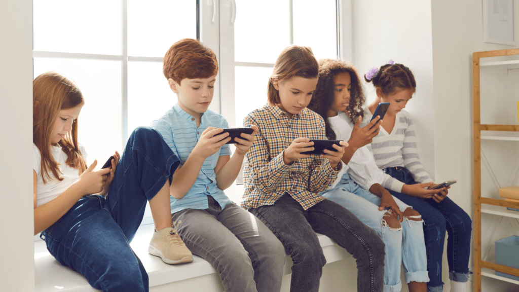 A group of kids playing mobile games together