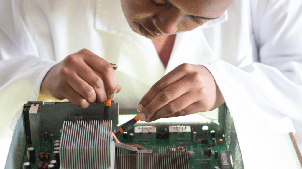 A person doing mechanical work on a graphic card