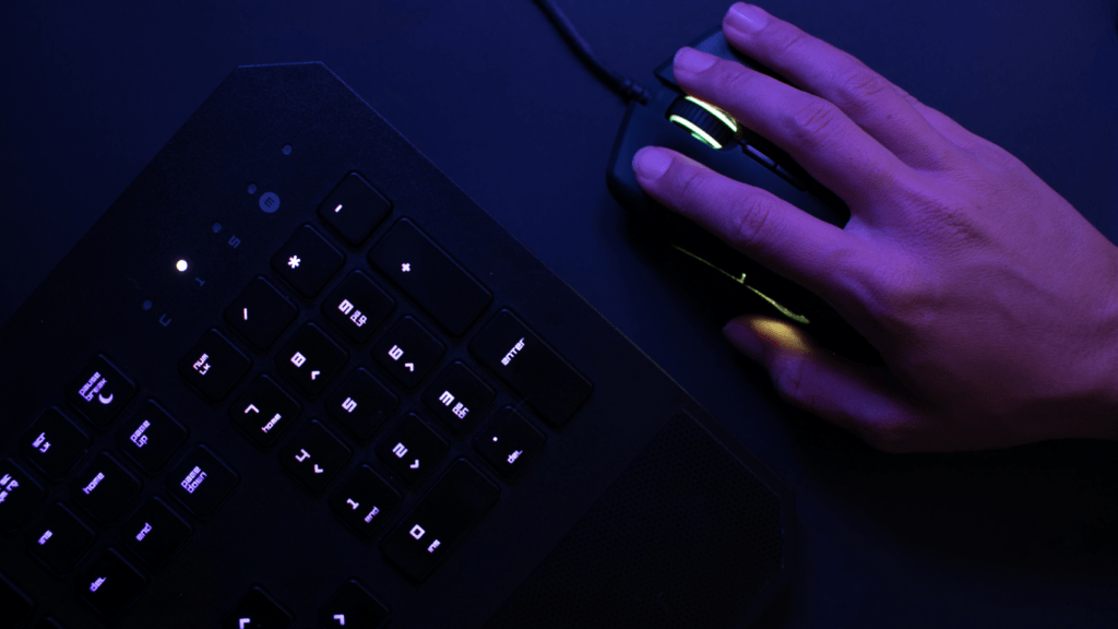 A person using keyboard and mouse for gaming