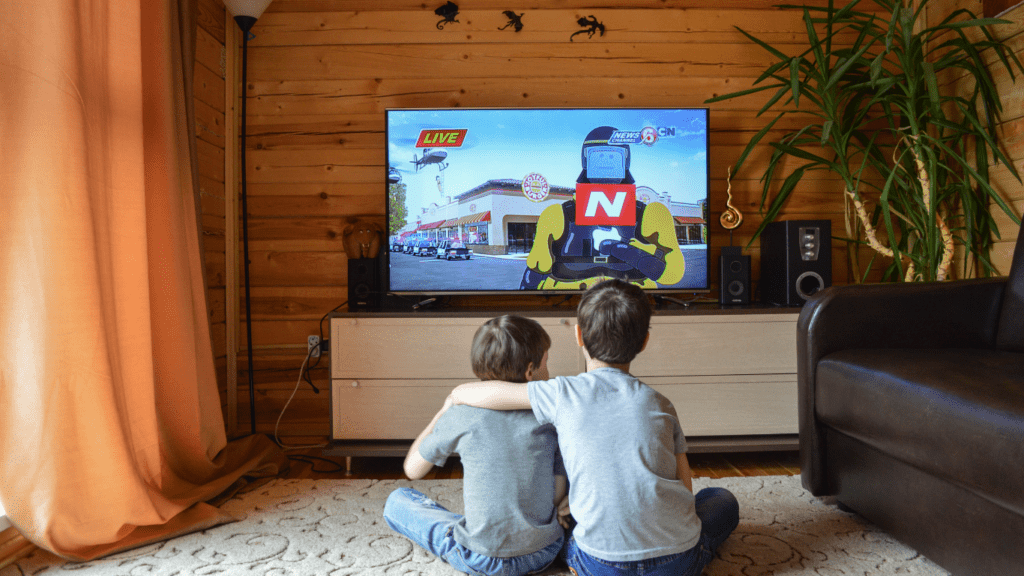 Two kids watching television together