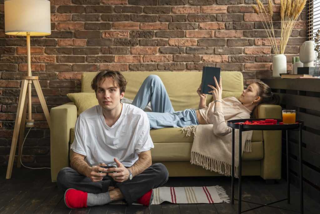 full shot couple indoors with book