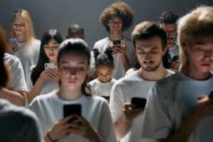 A diverse group of people engrossed in their smartphones, highlighting modern social connectivity.