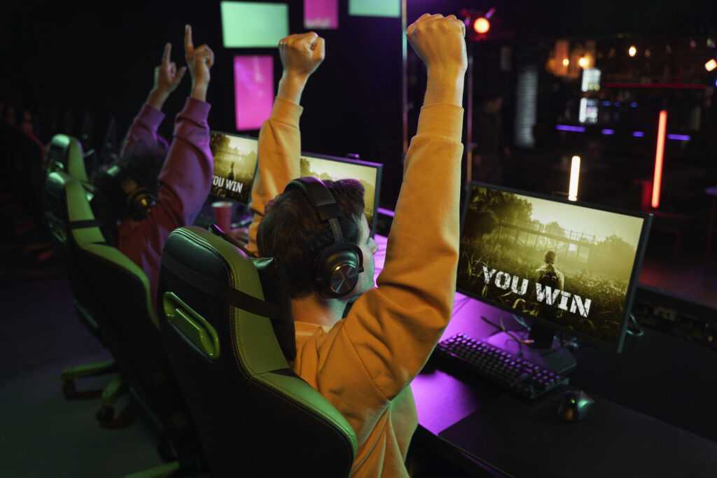 medium shot victorious gamers winning
