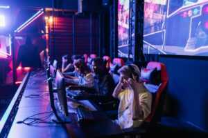 Focused gamers in a high-tech arena compete intensely, showcasing esports fervor.