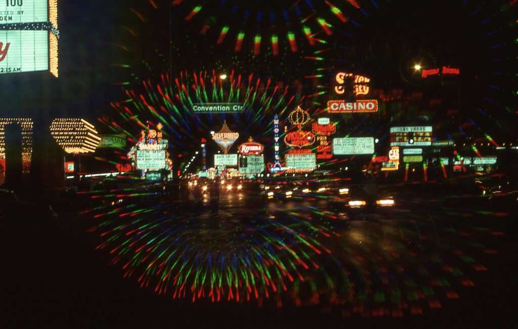 Explore the vibrant neon-lit streets of downtown Las Vegas at night, featuring casinos and bustling nightlife.