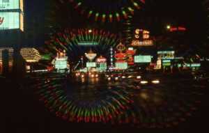 Explore the vibrant neon-lit streets of downtown Las Vegas at night, featuring casinos and bustling nightlife.